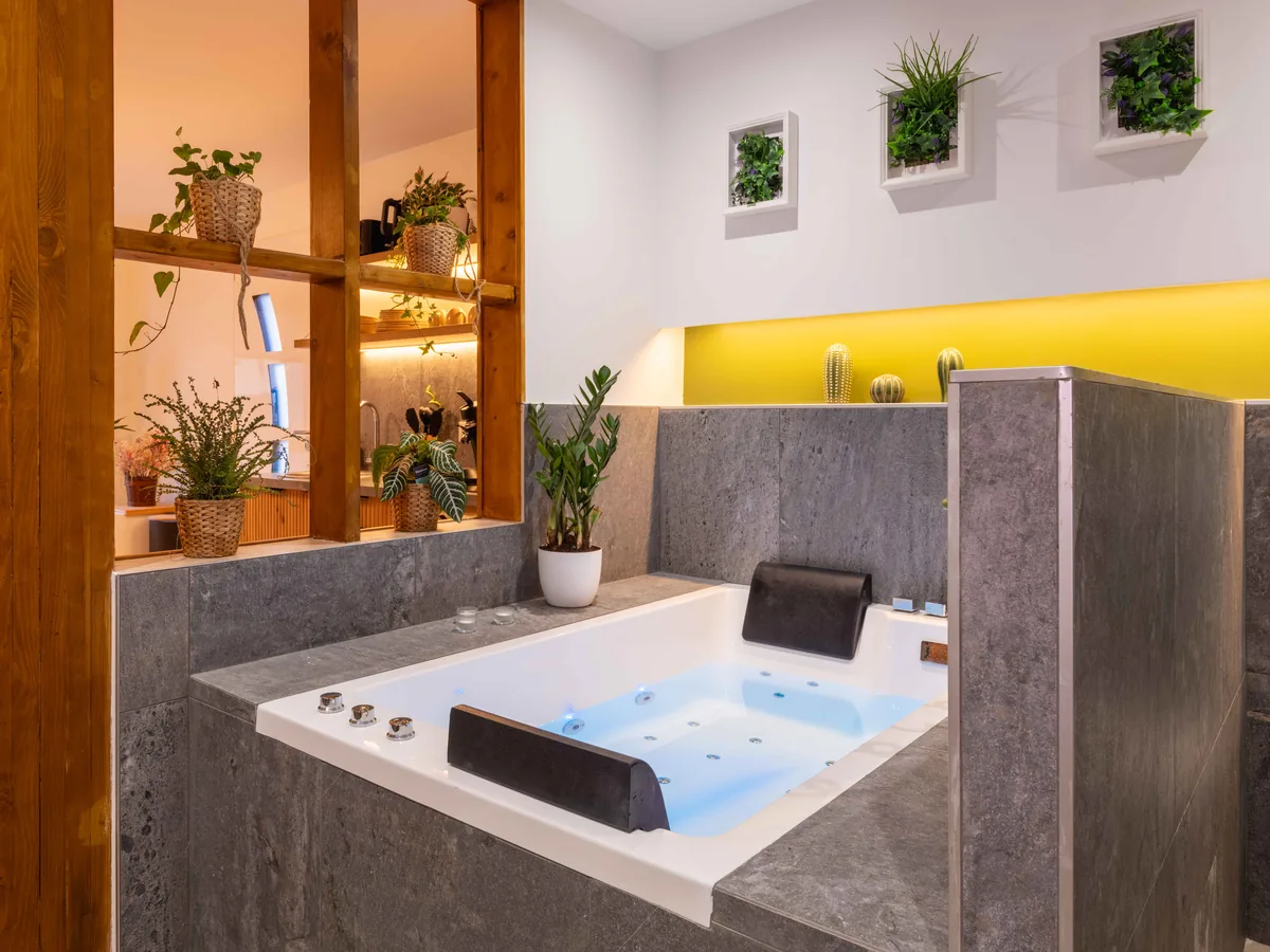 Baignoire balnéo double sous verrière — spa privatif La Parenthèse Essonne